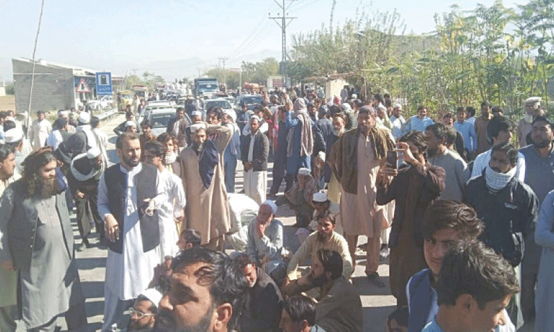 Protesters block Bajaur-Peshawar road on Thursday. — Dawn Protesters block Bajaur-Peshawar road on Thursday. — Dawn