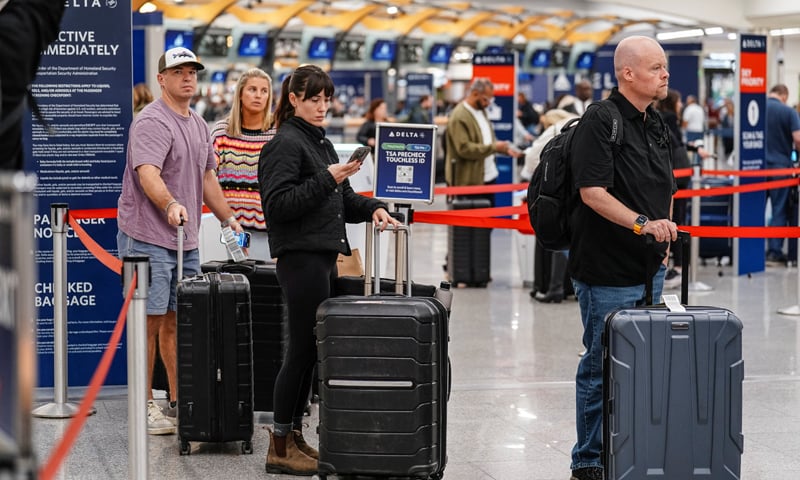 Travellers look at TV screens informing them about cancellations and delayed flights at Atlanta International Airport.&mdash;Reuters