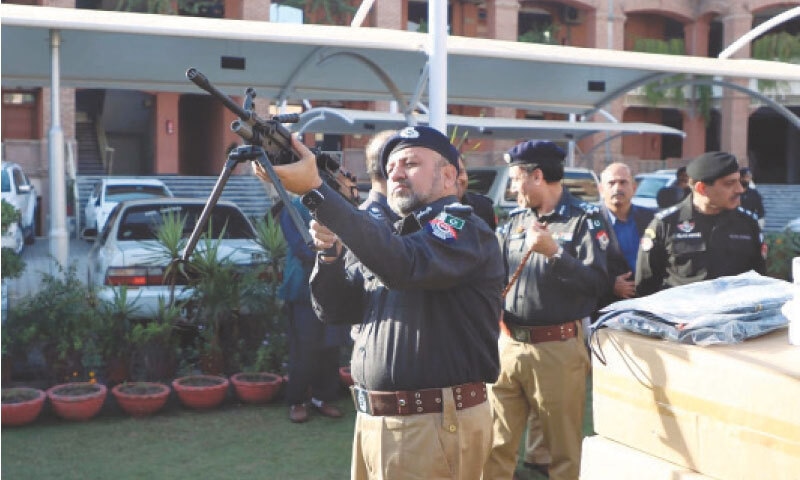 IGP Zulfiqar Hameed examines a gun at a ceremony at Central Police Office, Peshawar, on Friday. — White Star IGP Zulfiqar Hameed examines a gun at a ceremony at Central Police Office, Peshawar, on Friday. — White Star