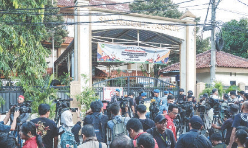 Journalists gather at the site of blast, that injured dozens of people, near a school in Jakarta.&mdash;AFP