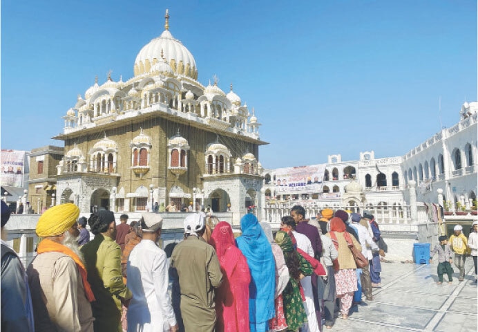 Devotees line up to pay homage at Gurdwara Panja Sahib. — Photos by the writer