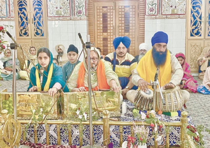 A woman Granthi recites from the Guru Granth Sahib.