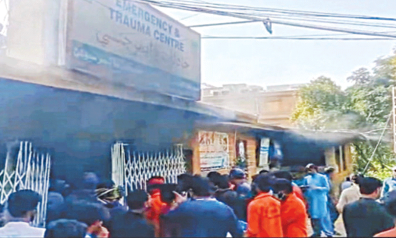 PEOPLE gather outside the fire-hit Trauma Centre at Syed Abdullah Shah Institute of Medical Sciences in Sehwan on Sunday.—Dawn PEOPLE gather outside the fire-hit Trauma Centre at Syed Abdullah Shah Institute of Medical Sciences in Sehwan on Sunday.—Dawn