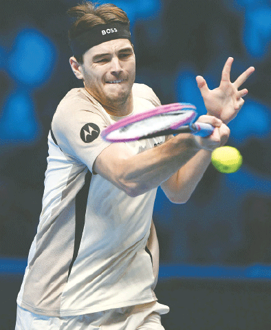 TURIN: Taylor Fritz of the US hits a return against Italy&rsquo;s Lorenzo Musetti during their ATP Finals match at Palasport Olimpico on Monday.&mdash;AFP