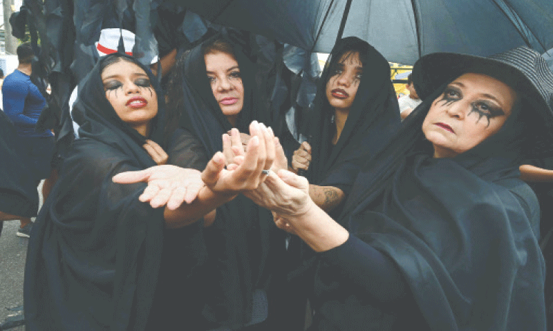 Activists fancy-dressed as widows gesture during a skit on &lsquo;the death of fossil fuels&rsquo; while taking part in a march on the sidelines of the COP30 UN Climate Change Conference in Belem, Brazil.&mdash;AFP