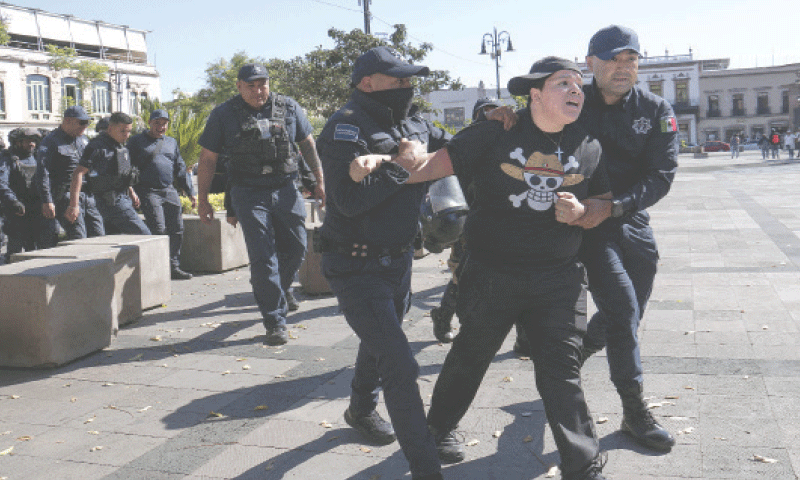 MORELIA (Mexico): A demonstrator is detained by police officers during a protest by supporters of the recently killed Michoacan Mayor Carlos Manzo, in Michoacan state.&mdash;Reuters