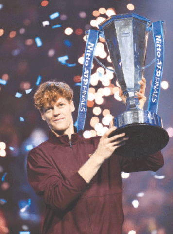 ITALY’S Jannik Sinner lifts the trophy after beating Carlos Alcaraz of Spain in the ATP Finals decider at Palasport Olimpico.—AFP