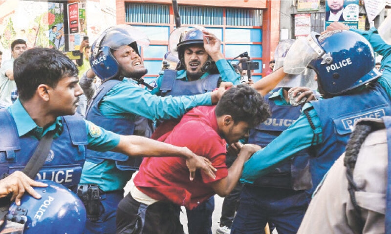 Policemen restrain a demonstrator attempting to damage the residence of Sheikh Mujibur Rahman, father of &lsquo;fugitive&rsquo; ex-PM Sheikh Hasina, after she was sentenced by a tribunal to be hanged for crimes against humanity.&mdash;AFP