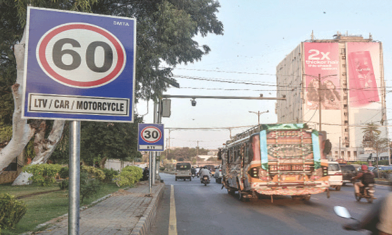 Vehicles move past newly installed speed limit signs on Sharea Faisal.&mdash;Fahim Siddiqi / White Star
