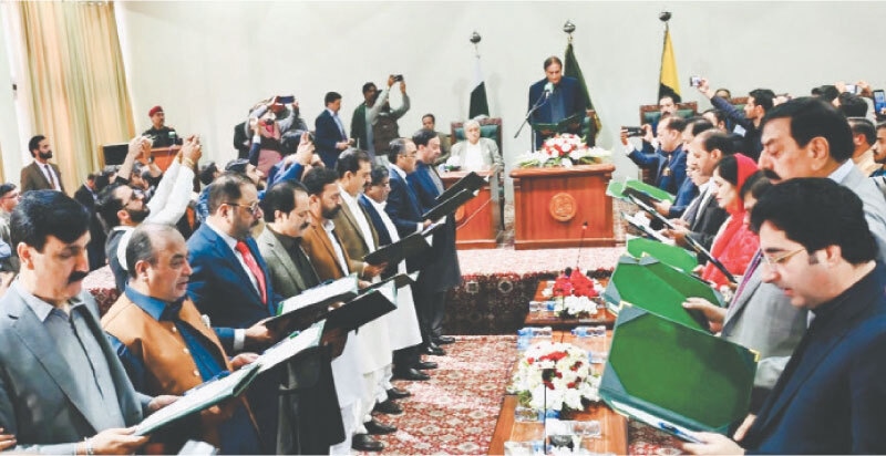 Acting AJK president Chaudhry Latif Akbar swears in the 18-member cabinet.&mdash;Photo by the writer