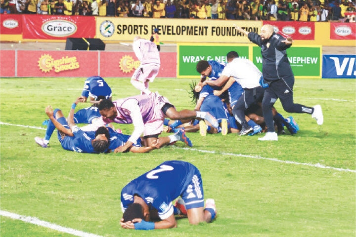 KINGSTON: Curacao coach Dean Gorre (R) and players celebrate after they qualify for the World Cup following their match against Jamaica at the National Stadium Independence Park.—Reuters