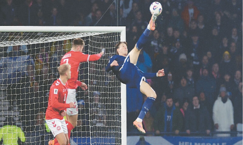 GLASGOW: Scotland’s Scott McTominay scores from a bicycle kick against Denmark during their 2026 World Cup qualifier at the Hampden Park.—Reuters GLASGOW: Scotland’s Scott McTominay scores from a bicycle kick against Denmark during their 2026 World Cup qualifier at the Hampden Park.—Reuters