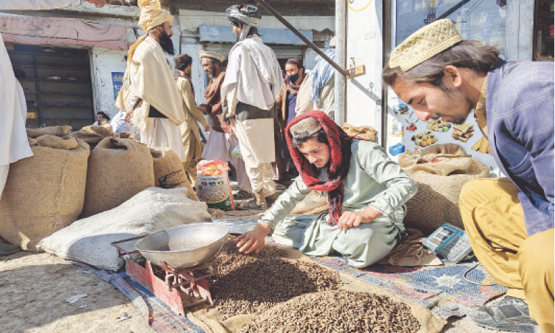 A vendor sells pine nuts in a Lower South Waziristan market. &mdash; Dawn