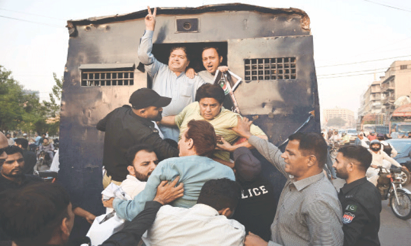 Police bundle the protesters into a prison van in a Saddar Locality. &mdash;AFP