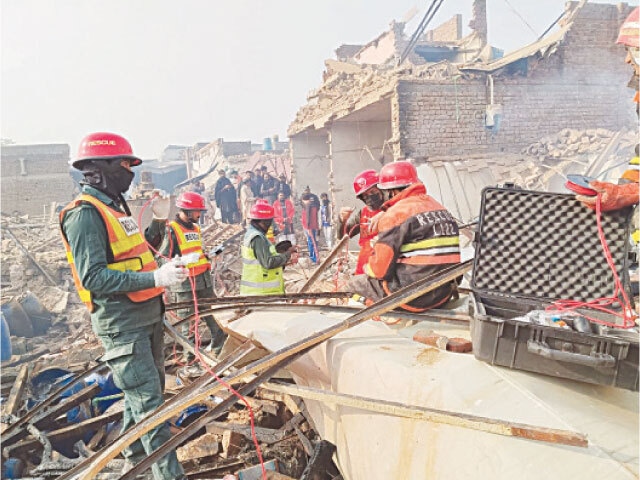  RESCUERS search for survivors after an explosion at a chemical factory.&mdash;Courtesy Rescue 1122 