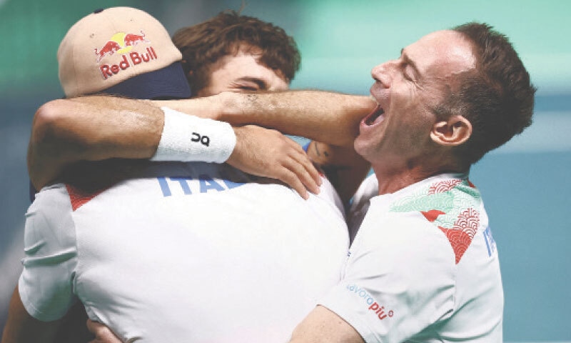 BOLOGNA: Italy&rsquo;s Flavio Cobolli (C) celebrates with team-mates and captain Filippo Volandri after winning his singles match against Belgium&rsquo;s Zizou Bergs in the Davis Cup semi-final at the SuperTennis Arena.&mdash;Reuters