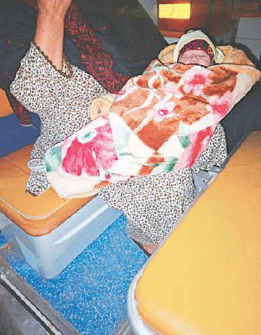 A newborn baby is being shifted back to his home on board the ambulance 1034.