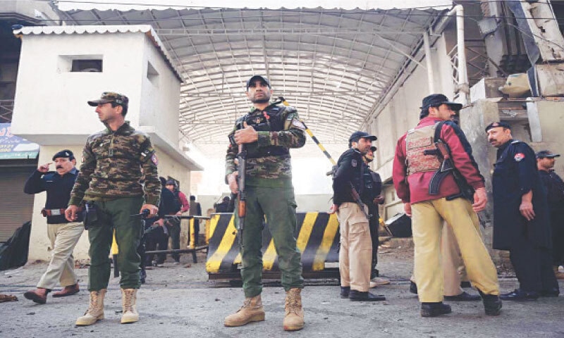 Security personnel stand alert outside the FC headquarters following a suicide attack.&mdash;APP