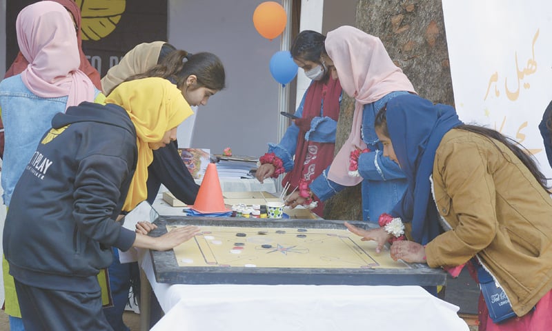 Students play a game of carom during the three-day 11th National Book Festival in Lok Virsa in Islamabad on Tuesday. &mdash; Photos by Mohammad Asim