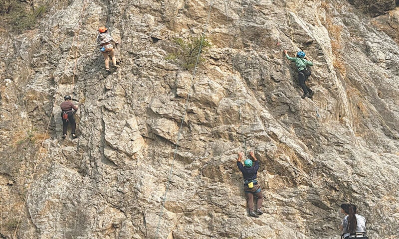 Sajid (top left) guides his charges in scaling a cliff | e adventures tours
