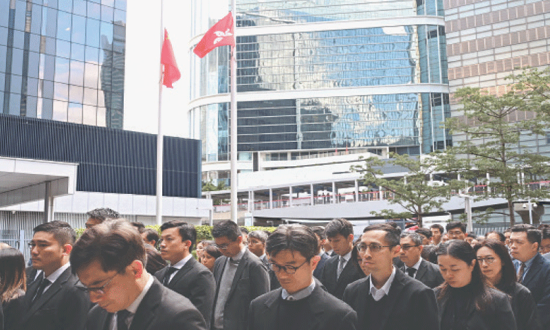 CHINESE and Hong Kong flags fly at half-mast as government officials file past after observing three minutes of silence to mourn victims of the residential estate fire.&mdash;AFP