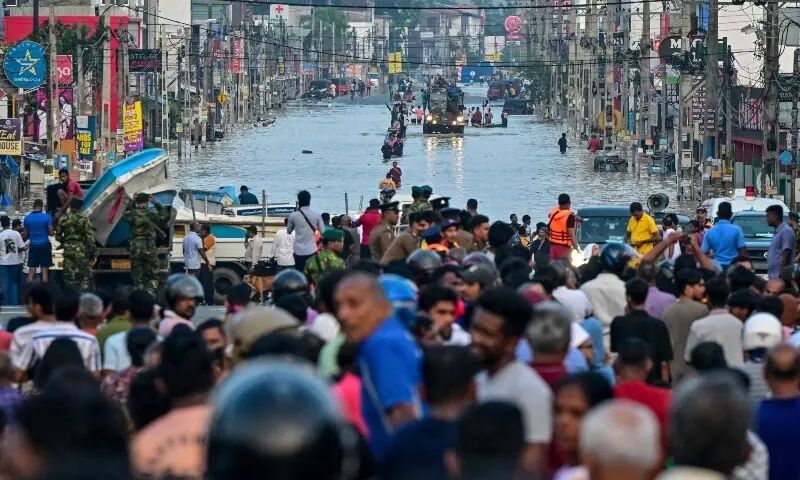 Army personnel ride a truck carrying boats to rescue stranded people as they wade through a flooded road after heavy rainfall in Wellampitiya on the outskirts of Colombo on November 30, 2025. —AFP Army personnel ride a truck carrying boats to rescue stranded people as they wade through a flooded road after heavy rainfall in Wellampitiya on the outskirts of Colombo on November 30, 2025. —AFP