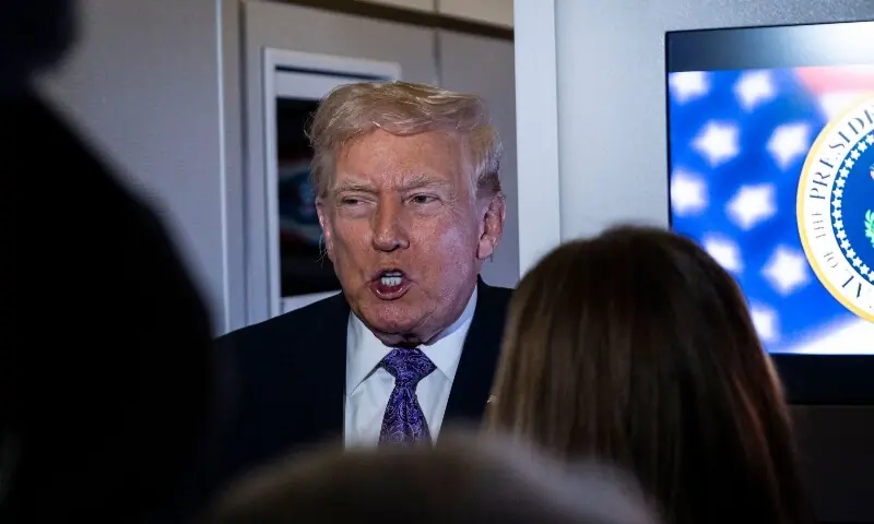 President Donald Trump speaks to the press aboard Air Force One en-route to Washington, DC on November 30, 2025. &mdash; AFP
