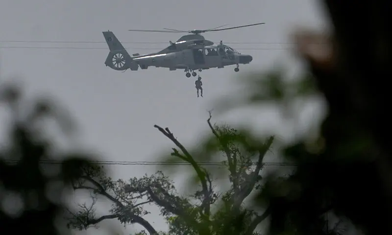 A Pakistan Navy helicopter airlifts a man who was stuck in a flooded area following Cyclone Ditwah in Kolonnawa, Sri Lanka on December 1. - Reuters