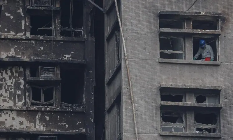 A police officer wearing personal protective equipment searches a fire-damaged apartment unit at the Wang Fuk Court housing complex, following the deadly fire on Wednesday, in Tai Po, Hong Kong, China, November 30, 2025. — Reuters A police officer wearing personal protective equipment searches a fire-damaged apartment unit at the Wang Fuk Court housing complex, following the deadly fire on Wednesday, in Tai Po, Hong Kong, China, November 30, 2025. — Reuters