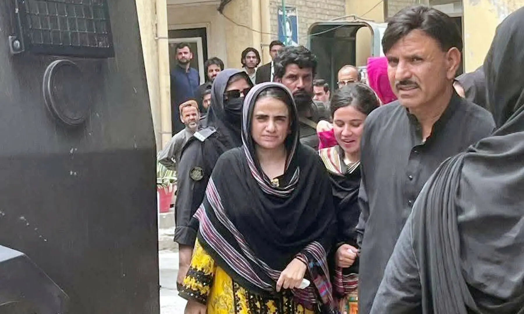 Baloch Yakjehti Committee leader Mahrang Baloch is being escorted by police personnel during her appearance at an anti-terrorism court in Quetta on July 8. &mdash; Sami Khan/PPI Images