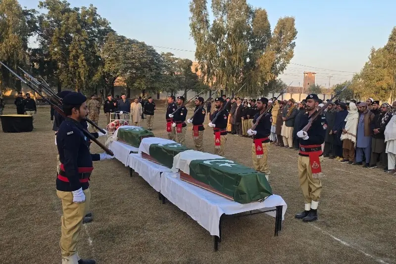 Security officials offer funeral prayers for the police personnel who were killed in attacks in Dera Ismail Khan on December 3. — AFP