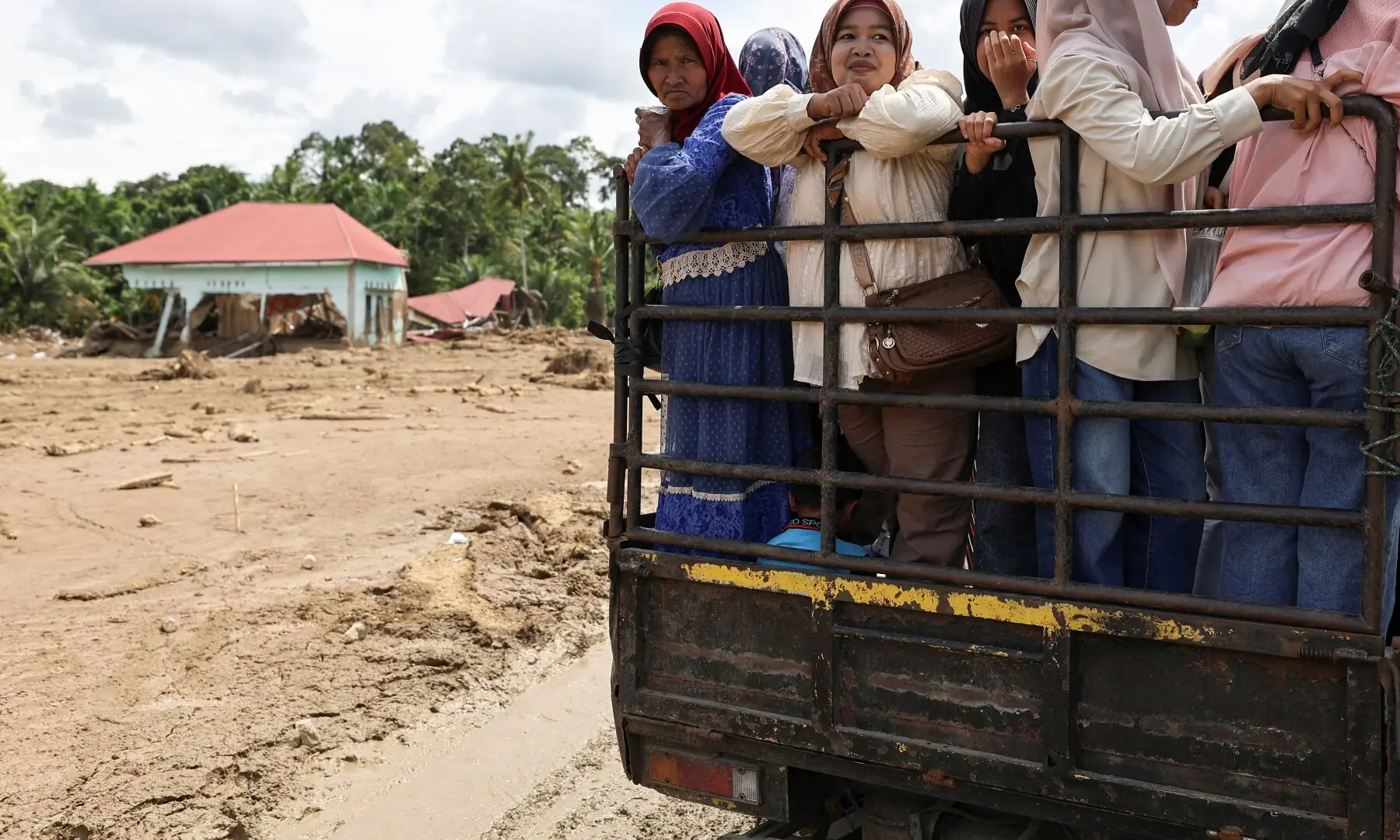 Local residents ride on a pickup truck to distribute relief in an area affected by deadly flash floods, Indonesia on Dec 4, 2025. — Reuters