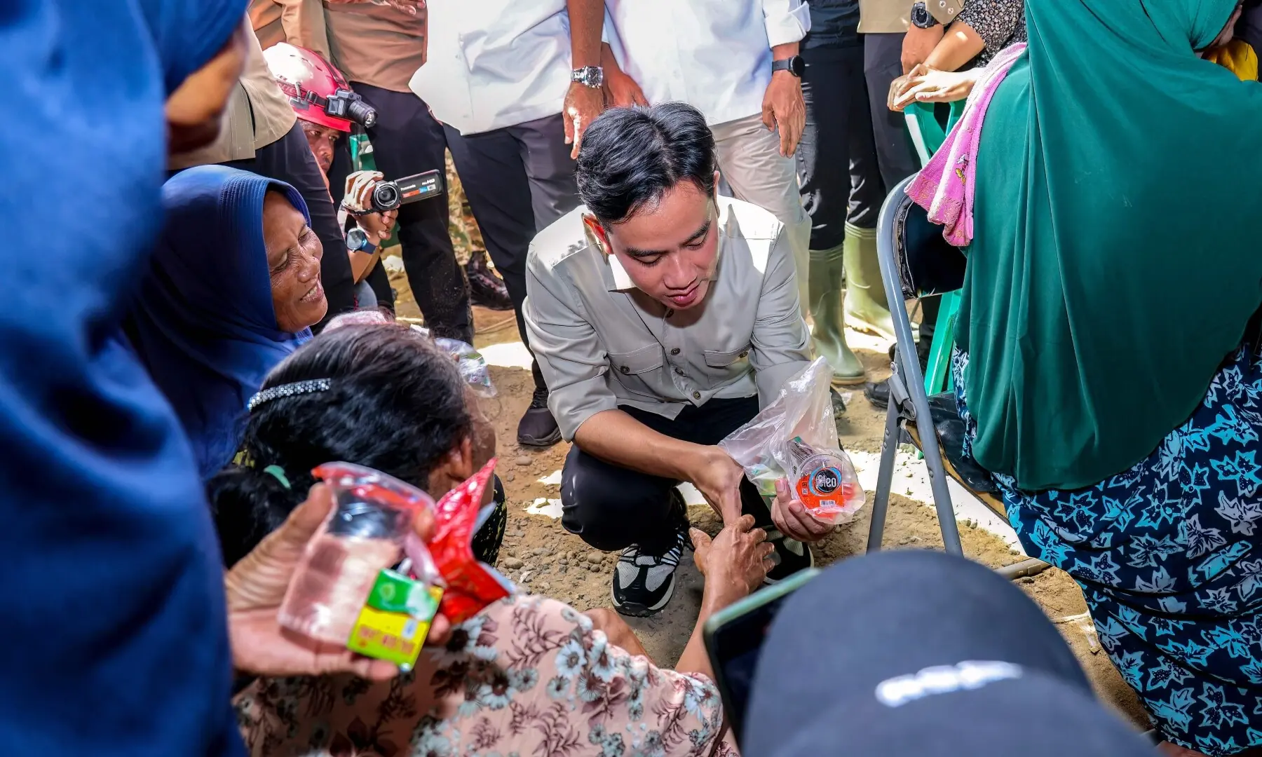 Indonesian Vice President Gibran Rakabuming Raka (C) meets with villagers who lost their homes at the refugee camp for victims of flash floods and landslides at Batu Gula village, South Tapanuli, North Sumatra, on Dec 4, 2025. — AFP