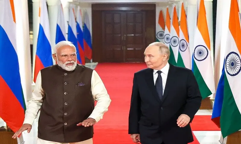 Russia&rsquo;s President Vladimir Putin and Indian Prime Minister Narendra Modi walk prior to an informal dinner at Modi&rsquo;s residence in New Delhi on December 4, 2025. &mdash;AFP