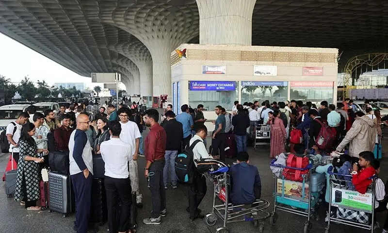 Passengers wait outside the IndiGo airlines ticketing counter at the Chhatrapati Shivaji Maharaj International Airport, after several IndiGo airlines flights were cancelled, in Mumbai, India on December 5. &mdash; Reuters