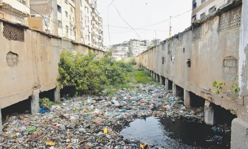 This file photo shows a drain in the Jubilee area clogged with all kinds of solid waste.—Fahim Siddiqi/White Star/File This file photo shows a drain in the Jubilee area clogged with all kinds of solid waste.—Fahim Siddiqi/White Star/File