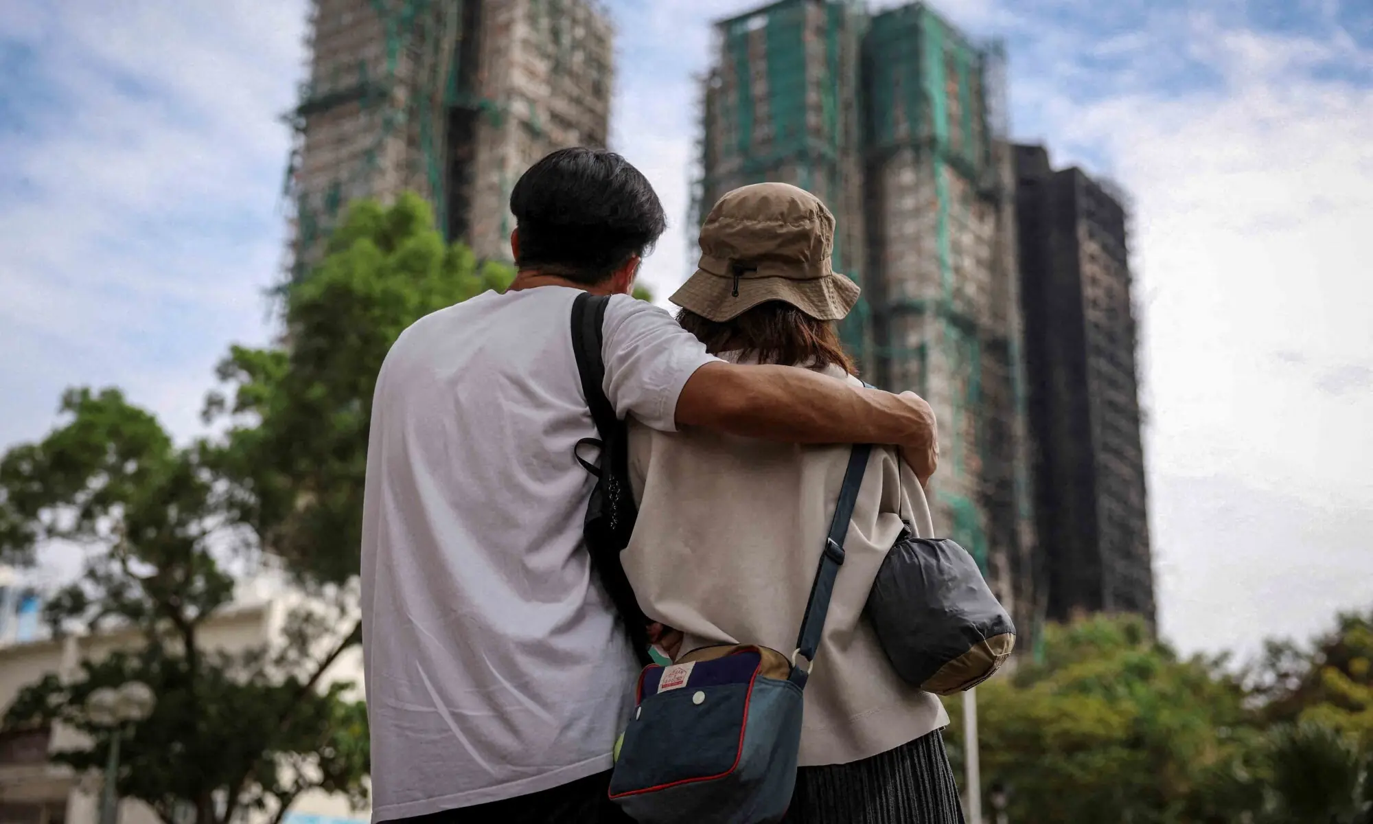 People look on near the Wang Fuk Court housing complex following the deadly fire on Wednesday, in Tai Po, Hong Kong, China December 1, 2025. — Reuters