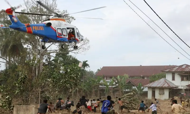 A police helicopter delivers relief supplies for survivors in an area affected by a deadly flash flood following heavy rains in Karang Baru, Aceh Tamiang regency, Aceh province, Indonesia, December 6. &mdash; Reuters
