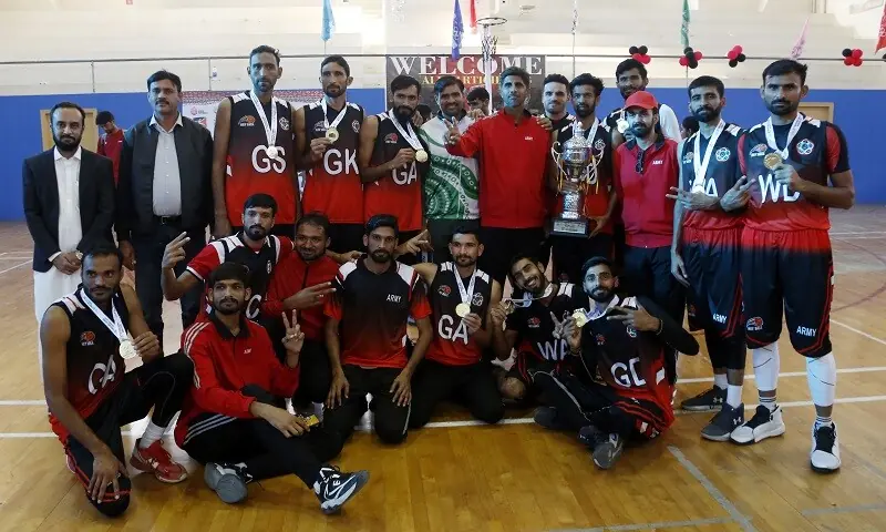 Players of Pakistan Army celebrate with their gold medals and the trophy after winning the men’s netball final during the National Games on Sunday.—Shakil Adil/White Star Players of Pakistan Army celebrate with their gold medals and the trophy after winning the men’s netball final during the National Games on Sunday.—Shakil Adil/White Star