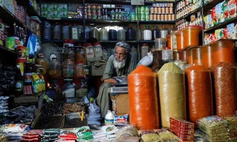 A shopkeeper waits for customers while selling spices and groceries items at the retail market in Karachi on June 11, 2020. &mdash; Reuters/File