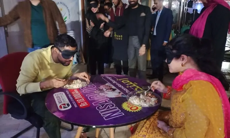 Rapper Ali Gul Pir and wife Dr Azeemah Nakhoda enjoy their dinner while being blindfolded. — Photo by the writer Rapper Ali Gul Pir and wife Dr Azeemah Nakhoda enjoy their dinner while being blindfolded. — Photo by the writer