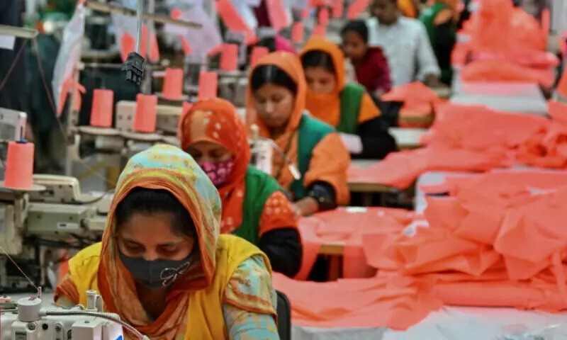 This photograph taken on December 29, 2024, shows garment workers sewing clothes at a Snowtex Group textile factory in Dhamrai, a sub-district in Dhaka.  &mdash; AFP