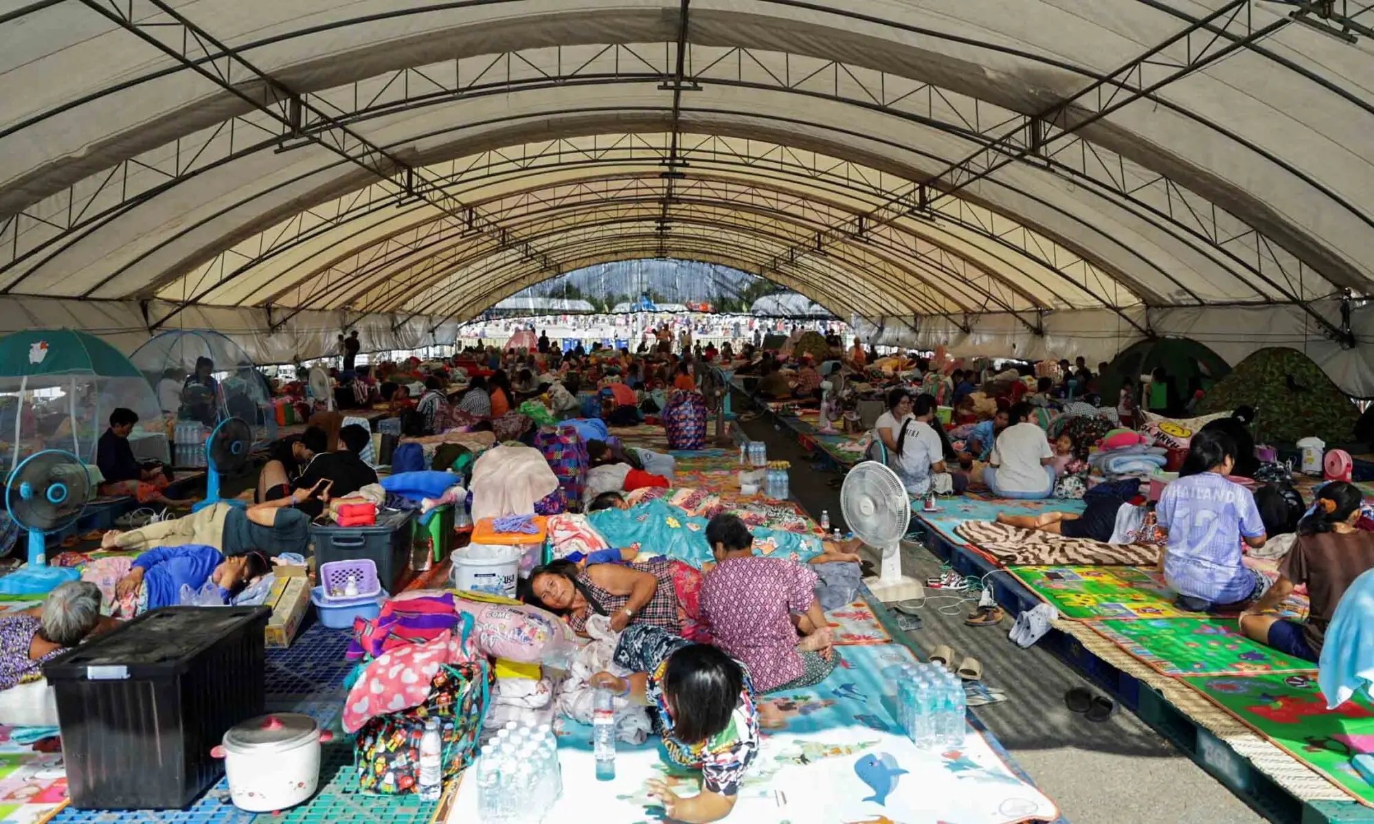 People rest at a shelter, following fresh military clashes between Thailand and Cambodia along parts of their disputed border, in Buriram province, Thailand, December 8, 2025. &mdash; Reuters