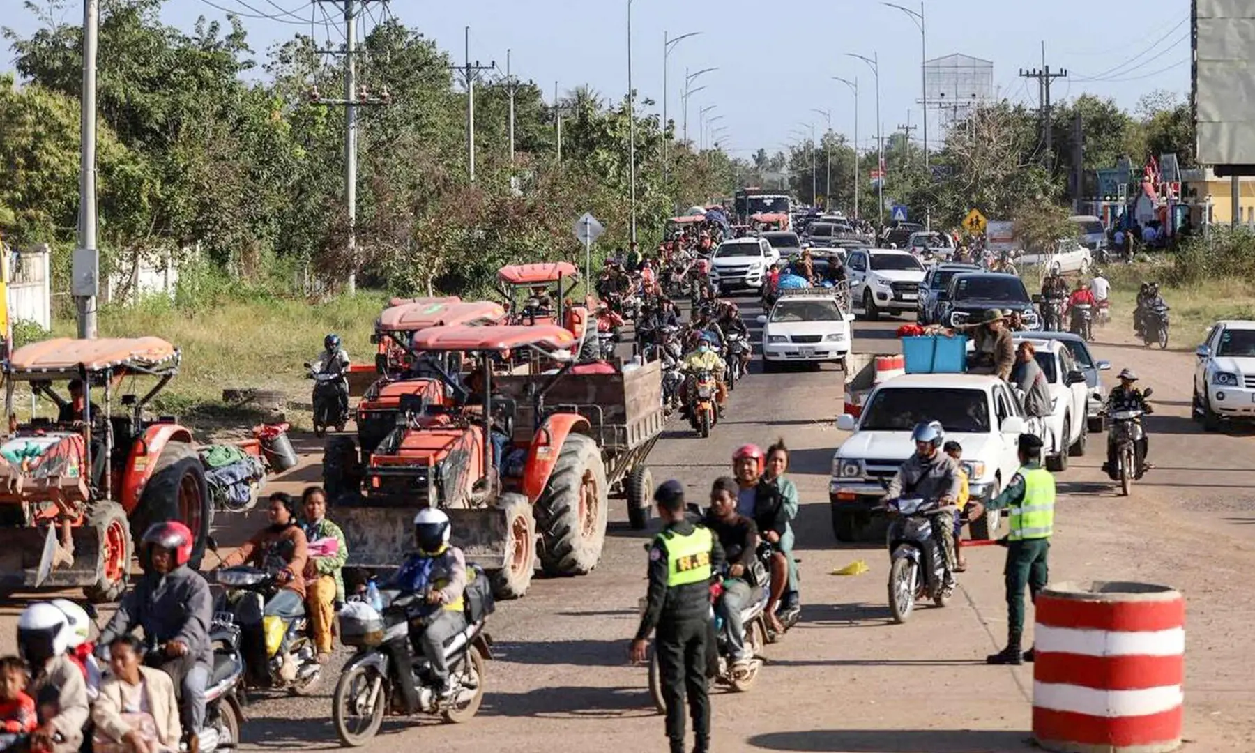 This handout photo taken and released by Agence Kampuchea Press (AKP) on December 8, 2025 shows local residents evacuating following clashes along the Cambodia-Thailand border in Oddar Meanchey province. — AFP This handout photo taken and released by Agence Kampuchea Press (AKP) on December 8, 2025 shows local residents evacuating following clashes along the Cambodia-Thailand border in Oddar Meanchey province. — AFP