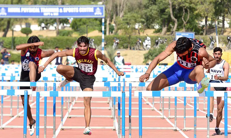 Athletes take part in the 100m hurdles event of the National Games at NPT&SC in Karachi on December 8. 2025.&mdash;Tahir Jamal/White Star
