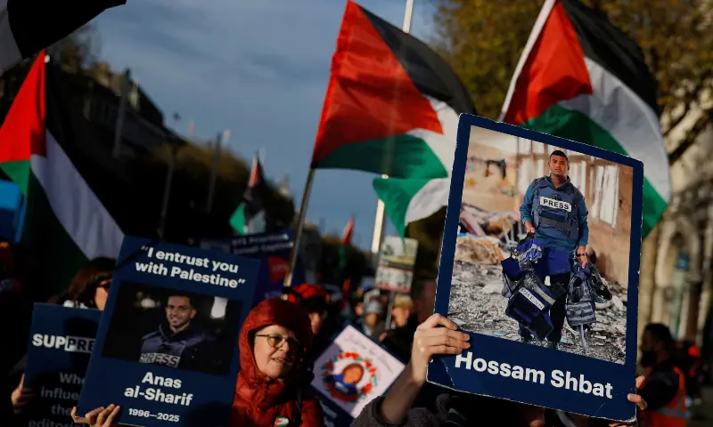 Demonstrators hold placards of slain journalists from Gaza Hossam Shbat and Anas al-Sharif, in support of Palestinians during a march on the International Day of Solidarity, in Dublin, Ireland on November 29, 2025. &mdash; Reuters