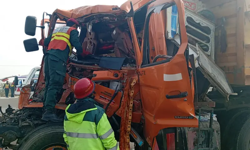 Rescue 1122 personnel photographed near a trailer truck after an accident on the M% Motorway on Dec 9. &mdash; Photo courtesy Rescue 1122