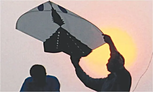 A picture shows a man preparing kite-flying. &mdash; AFP/file