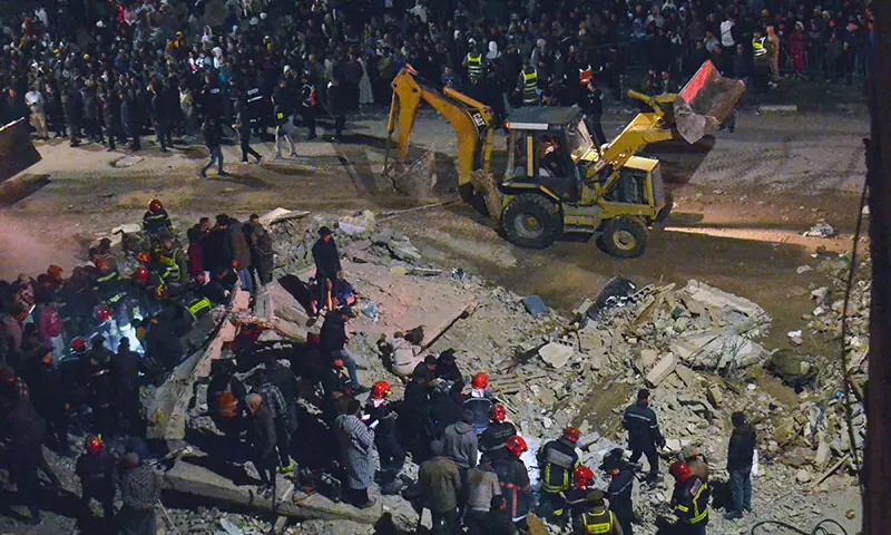 Emergency personnel search for victims in the rubble of two collapsed buildings in the Al Massira area of Fez, Morocco on December 9. — AFP