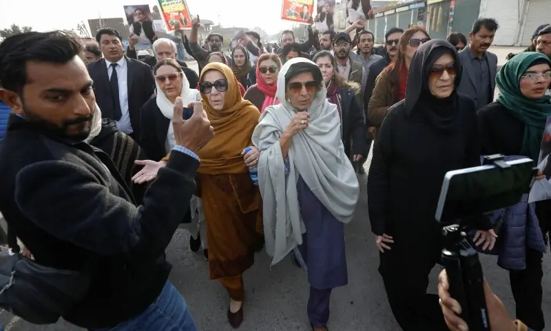 Aleema Khanum, Uzma Khanum and Noreen Niazi, sisters of jailed former prime minister Imran Khan, walk with supporters during a protest over concerns about their brother&rsquo;s health, on a road leading to Adiala jail in Rawalpindi on December 9, 2025. &mdash; Reuters